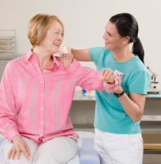 caregiver and senior doing physical therapy